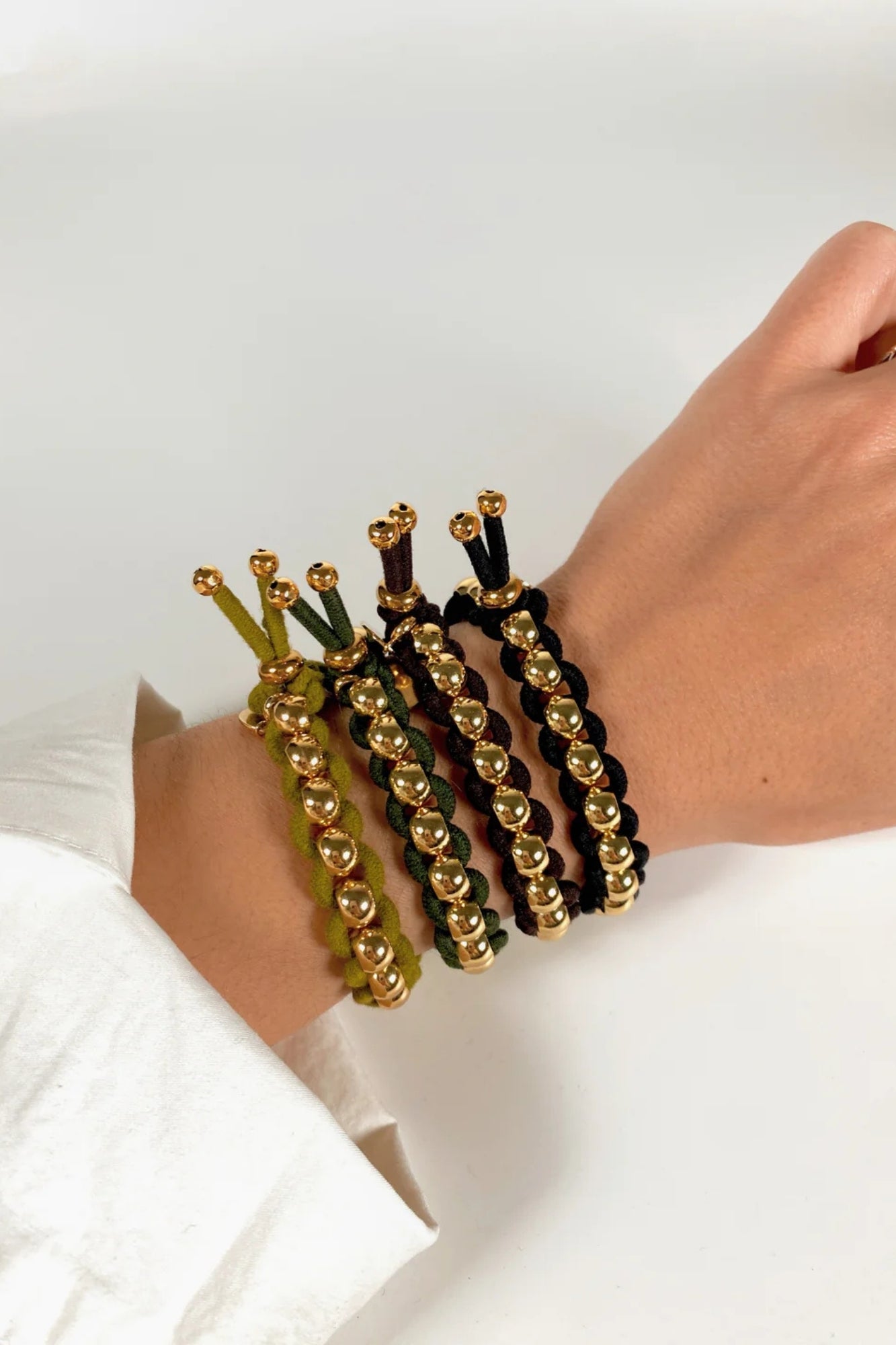 BICHOU ROUND GOLD BEADS AND BLACK ELASTIC HAIR TIE